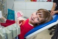 A happy girl with a jaw mock in a dentistÃ¢â¬â¢s office